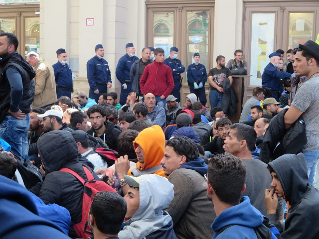 Interno stazione, binario n.9: immigrati in attesa del treno per Vienna
