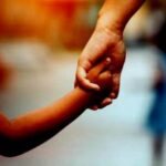 Mother and daughter holding hand together with love in vintage color tone